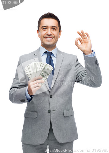 Image of smiling businessman with american dollar money