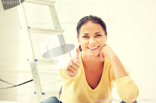 Image of lovely housewife making repairing works