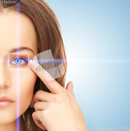 Image of beautiful woman pointing to eye