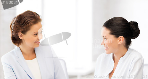 Image of two businesswomen having discussion in office