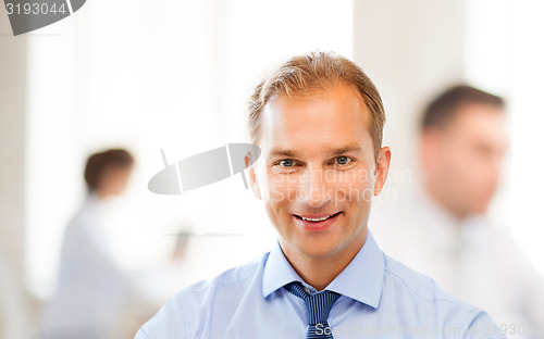 Image of smiling businessman in office