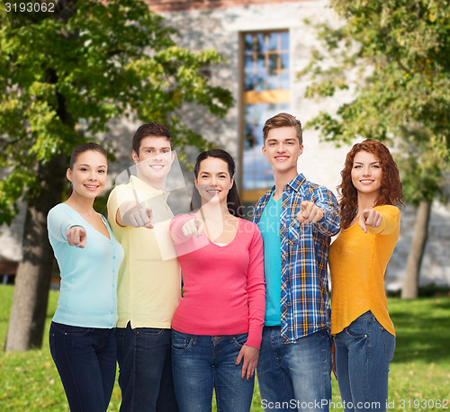 Image of group of smiling teenagers over campus background