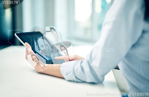 Image of close up of woman hands with tablet pc at office
