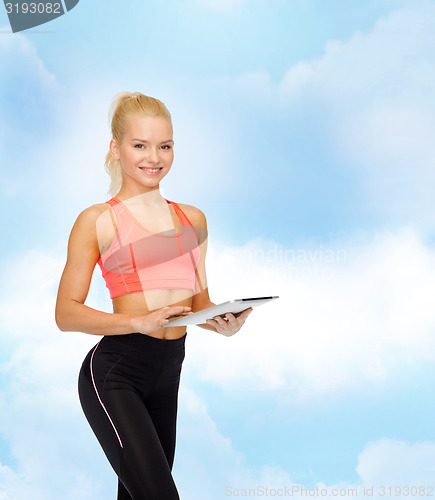 Image of smiling sporty woman with tablet pc computer