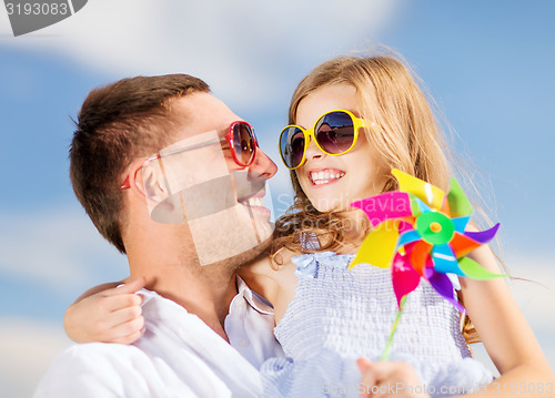 Image of happy father and child in sunglasses over blue sky