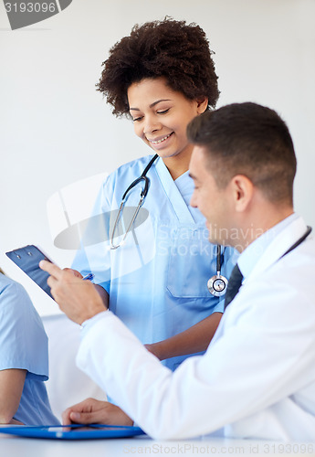 Image of group of happy doctors meeting at hospital office