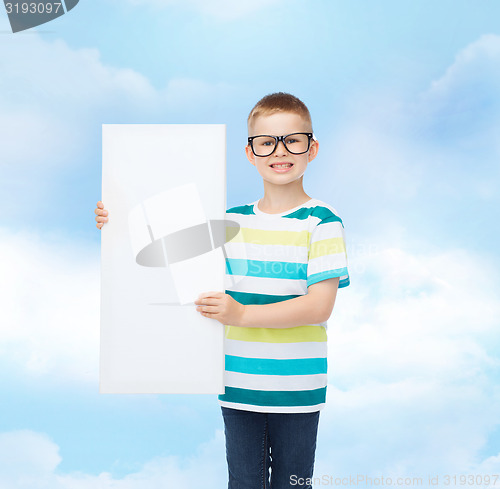 Image of smiling boy in eyeglasses with white blank board