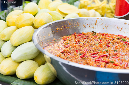 Image of chilly wok or pilaf and mango at street market