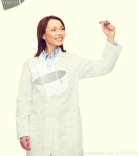 Image of young female doctor writing something in the air