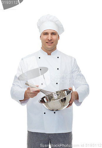 Image of happy male chef cook whipping something with whisk