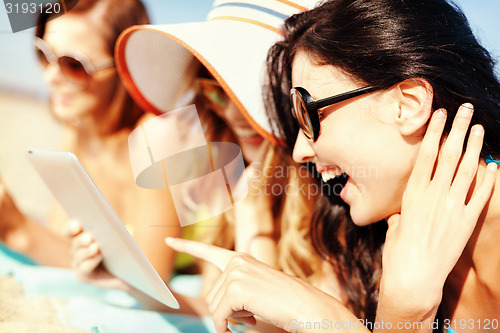 Image of girls with tablet pc on the beach