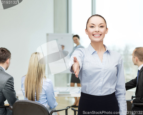 Image of businesswoman with opened hand ready for handshake