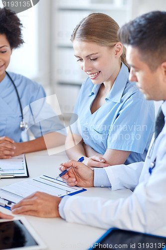 Image of group of happy doctors meeting at hospital office