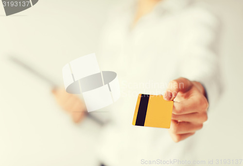 Image of woman showing gold credit card