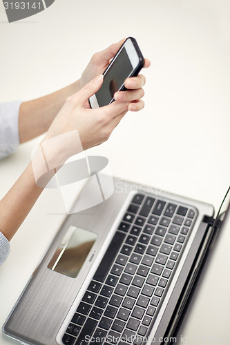 Image of close up of woman texting on smartphone at office