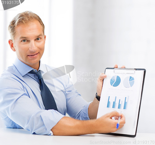 Image of businessman showing graphs and charts