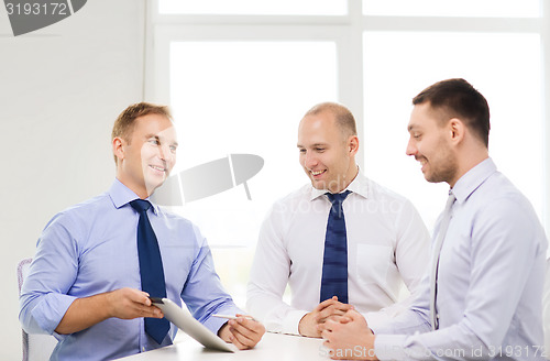 Image of business team working with tablet pc in office