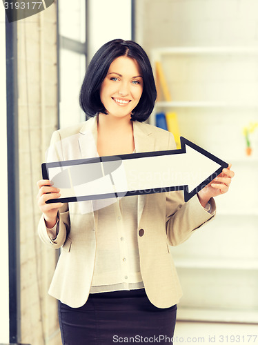 Image of businesswoman with direction arrow sign