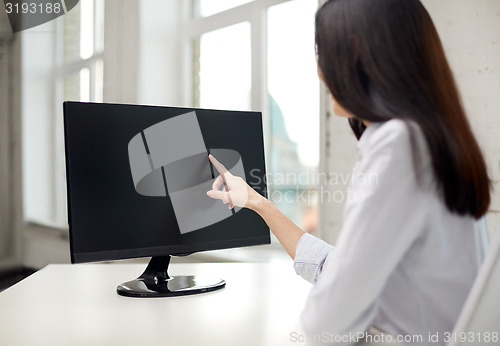 Image of close up of woman with computer monitor in office