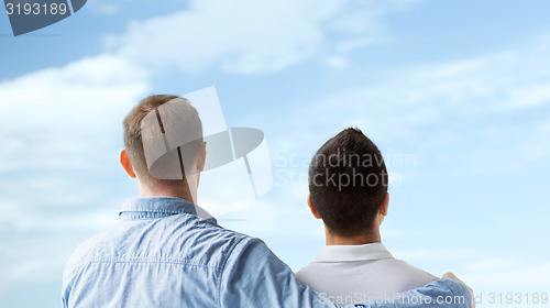 Image of close up of happy male gay couple hugging