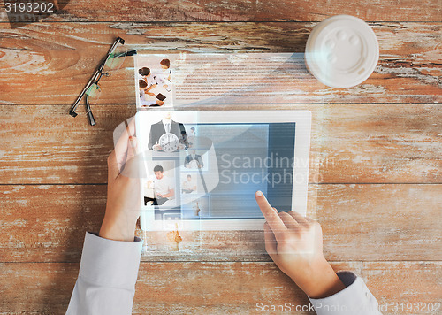 Image of close up of hands with tablet pc and web page