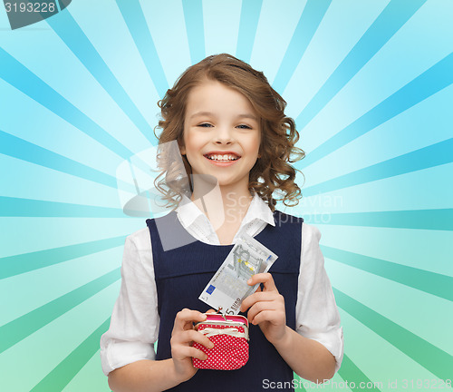 Image of happy girl with purse and paper money