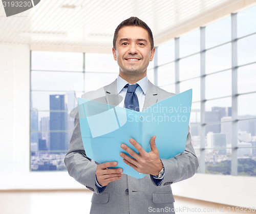 Image of happy businessman with open folder