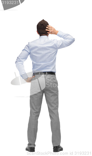 Image of businessman scratching his head from back