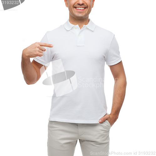 Image of smiling man in t-shirt pointing finger on himself