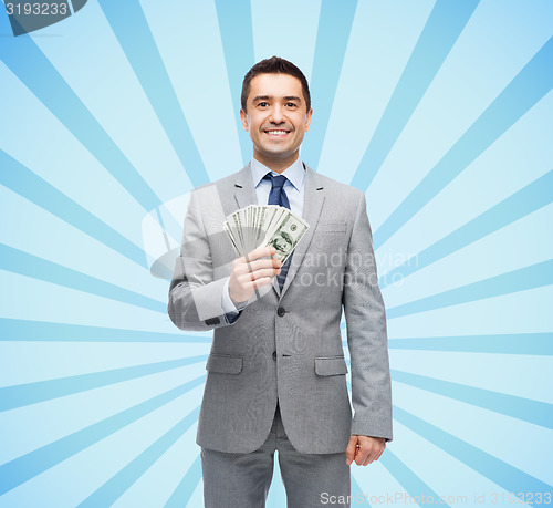 Image of smiling businessman with american dollar money