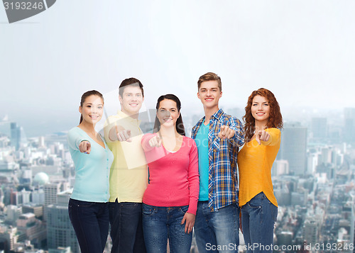 Image of group of smiling teenagers over city background