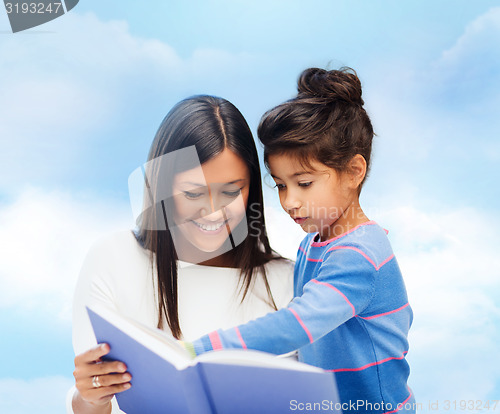 Image of happy mother and daughter reading book