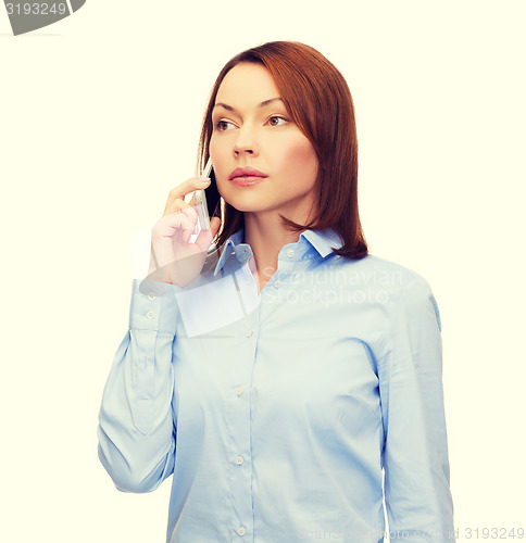 Image of young calm businesswoman with smartphone