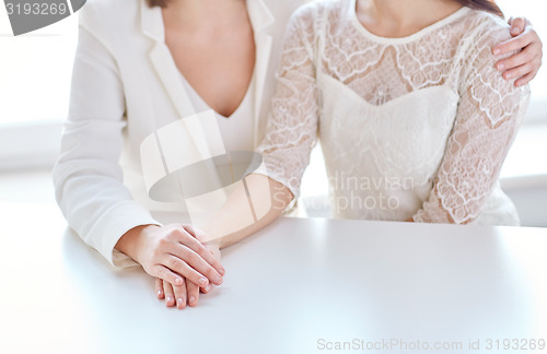 Image of close up of happy married lesbian couple hugging