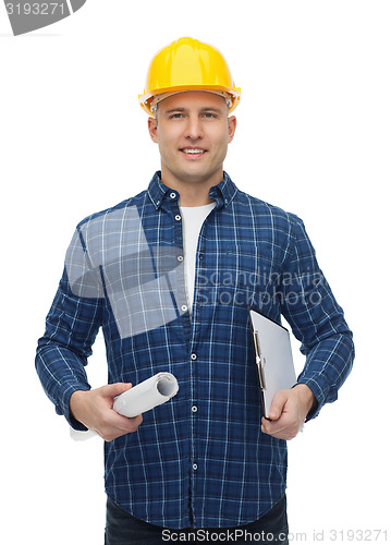 Image of smiling male builder in helmet with blueprint