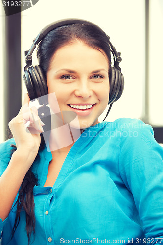 Image of happy teenage girl in big headphones