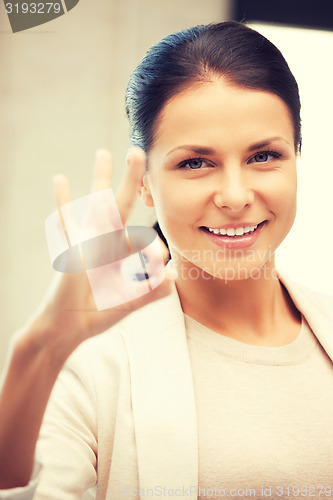 Image of lovely teenage girl showing ok sign