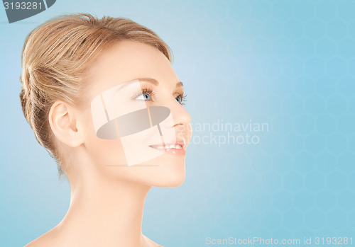 Image of beautiful young woman face over blue background
