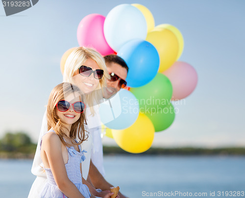 Image of family with colorful balloons