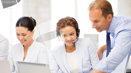 Image of group of people working in call center