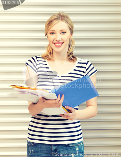 Image of happy teenage girl with books and folders