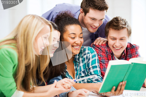 Image of students reading book at school