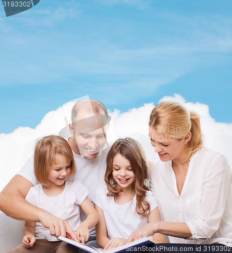 Image of happy family with book at home