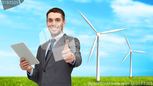 Image of smiling businessman with tablet pc computer