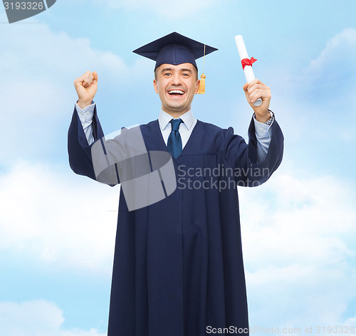 Image of smiling adult student in mortarboard with diploma