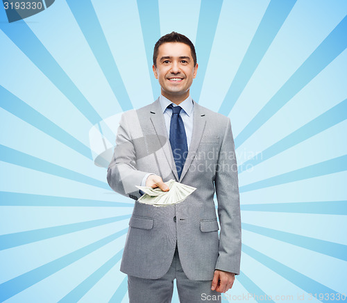 Image of smiling businessman with american dollar money