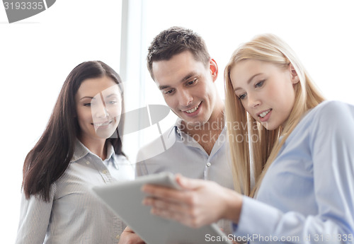 Image of business team working with tablet pc in office