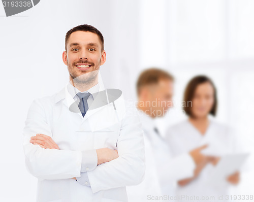 Image of smiling male doctor in white coat