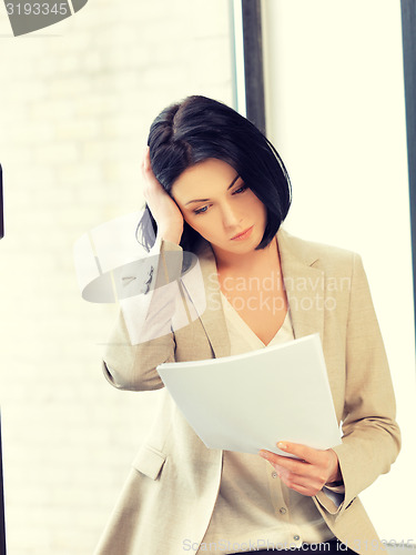 Image of calm woman with documents