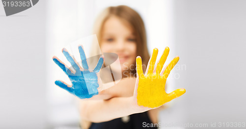 Image of girl showing painted hands